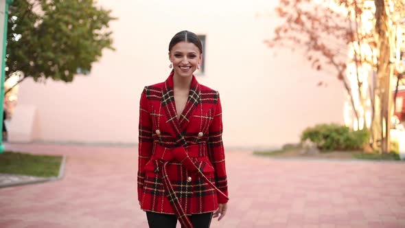 Adorable Young Happy Girl in Red Trendy Clothing Walking Outdoor Turning Around Looking at Camera