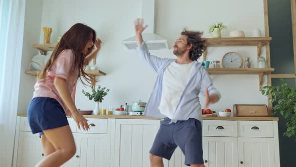 Lovely Couple Having a Fun Together While Dancing at the Bright Kitchen. alt