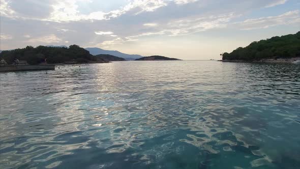 Drone shot of people swimming in the water in Albania alt