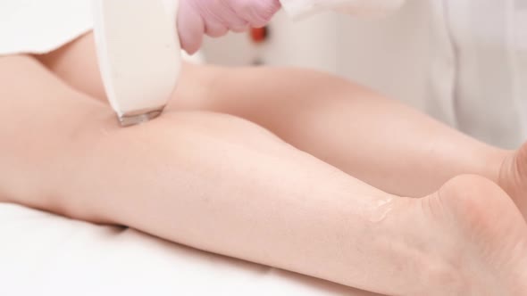 Flash of Diode Laser Hair Removal Beautician Removes Hair on Beautiful Female Legs Hair Removal for alt