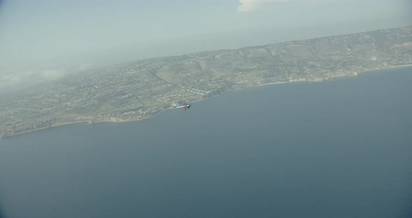 Aerial helicopter shot, pan across vast glacial valley at golden hour, drone footage alt