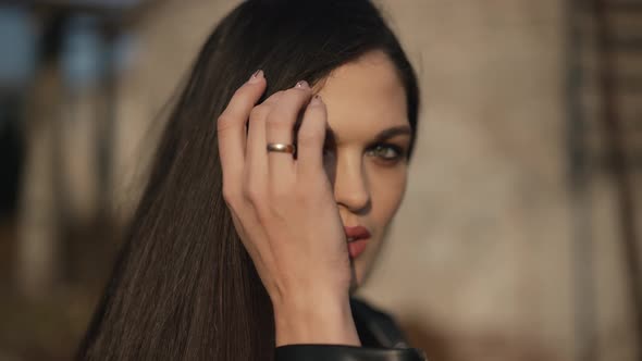 Young Woman Straightens Her Hair alt