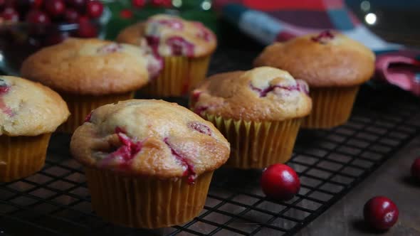 Revers dolly shot with homemade cranberry orange muffins on cooling rack, Christmas decoration alt