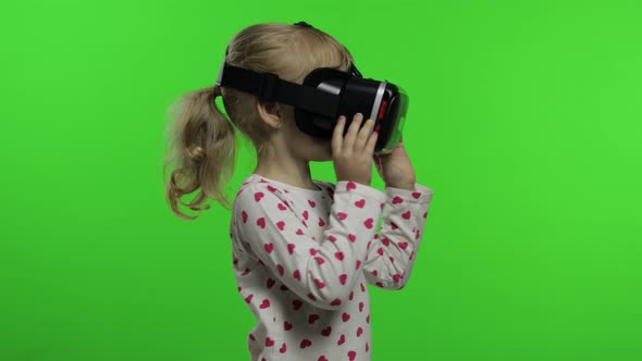 Child Girl Using VR Headset Helmet To Play Game. Watching Virtual Reality 3d 360 Video. Chroma Key alt