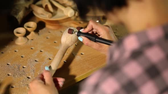 Female Using Power Wood Working Tools Graver for Wooden Utensils Spoon