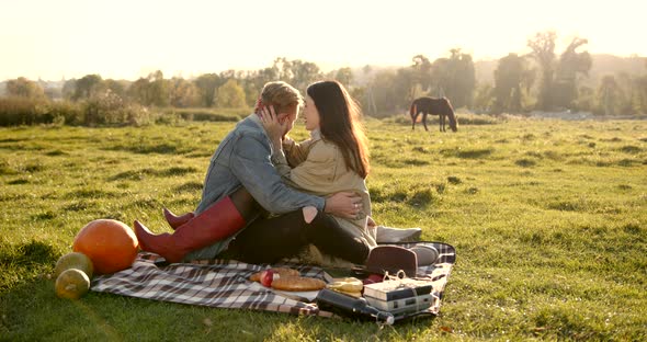 Woman Sitting with Boyfriend on a Plaid alt