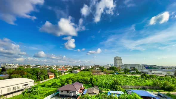 Bangkok. Blue cloudy sky at summer day with Urban forest and Cityscape wide angle.