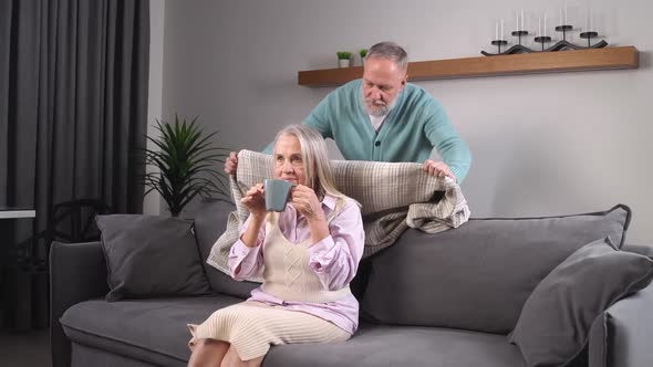 Elderly Grayhaired Man Covers His Wife with a Blanket Taking Care of Their Loved Ones Adult People alt