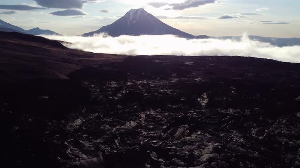 lava floor at dawn against the background of a volcano