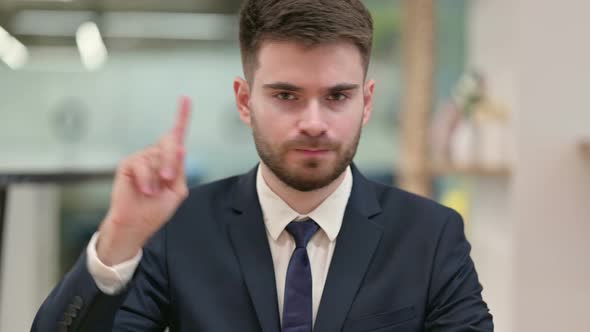 Young Businessman Saying No By Finger Sign alt