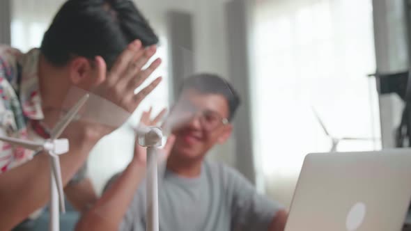 Blur Happy Teacher And Student Use Laptop Computer Programming Electric Wind Turbine alt