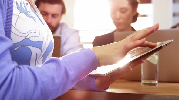 Female business executive using digital tablet alt