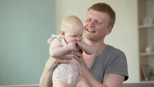 Happy Father Playing With Cute Little Baby Girl, Enjoying Conscious Parenthood alt