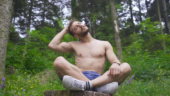 Man meditating in the forest. alt