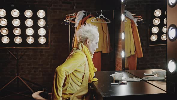 Tired Mime Comes to Sit at Table Removing Makeup After Show alt