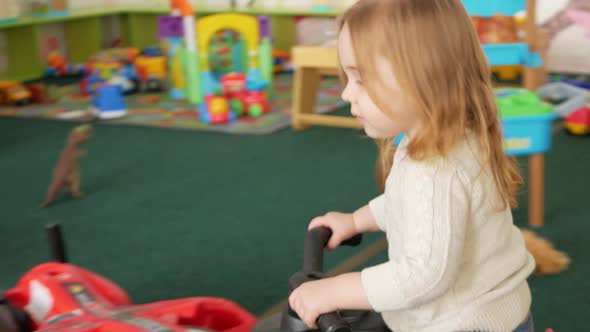 Girl Rides Car in Children's Center Game