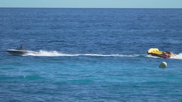 Happy People Enjoying Banana Boat Ride, Cool Attraction at Sea Resort, Summer alt