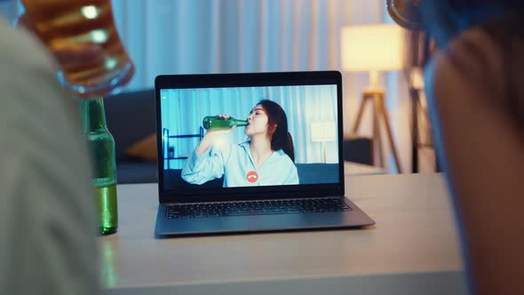 Young Asia female drinking beer having fun happy moment night party event online celebration.