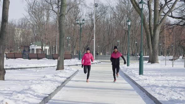 Man and Woman Running in Winter Park alt