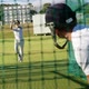 Cricket players practicing in the nets during a practice session