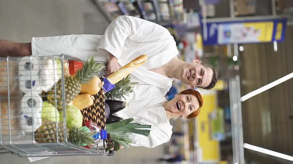 Young Couple Family Emotionally React on Discounts in Grocery Store in Bathrobe