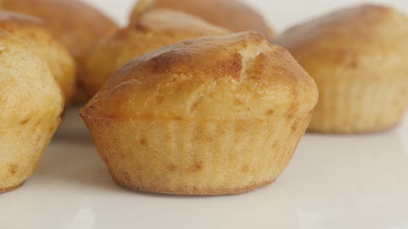Muffin shaped cornbread slow tilt 4K 2160p 30fps UltraHD footage - Tasty cornmeal on white plate 384 alt