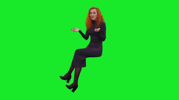 Elegant Woman in Long Dress Sitting While Telling the Story and Gesturing on Green Screen 