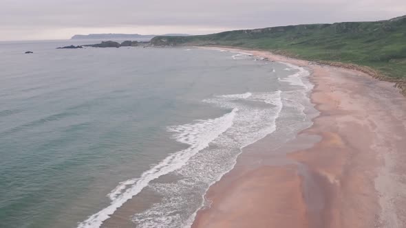 Stunning sandy beach, Antrim Coast of Northern Ireland. Aerial drone view alt