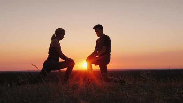 Mom and Her Adult Son Play Sports Together in a Beautiful Sunset Setting alt