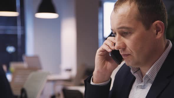 Business Person Talking on Cellular About Meeting in Company