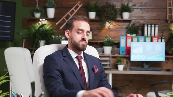 Zoom Out Shot of Young Office Worker Typing an E-mail alt