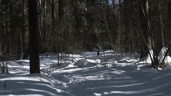 A Miniature Girl on Skis Emerges From the Depths of the Forest alt
