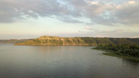 Aerial view of wide Dnister river and distant rocky hills in Bakota area, part of the National park  alt