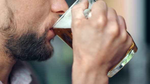 Mouth of Mature European Bearded Man Drinking Cold Dark Fresh Beer Holding Big Glass Mug alt