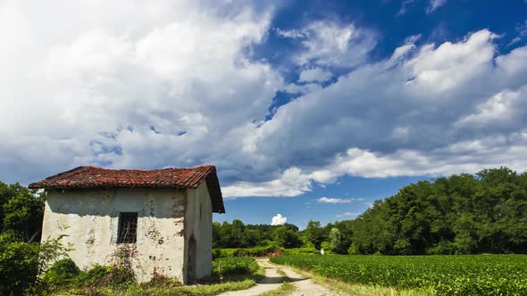 Time Lapse of a Country Landscape Ruined House in the Left Side Agricultural Field on the Right Side alt