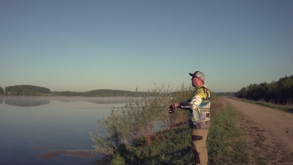 Man Fishing on Wooden Pier Near Lake