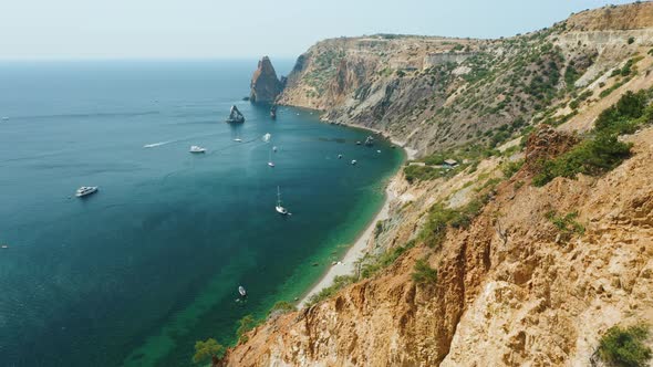 Aerial View of Calm Azure Sea and Volcanic Rocky Cliffs of Mys Fiolent alt