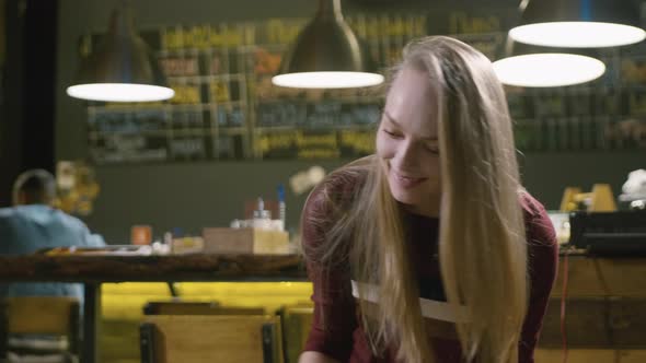 Young smiling woman playing tabletop soccer