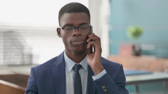 Young African Businessman Talking on Phone alt