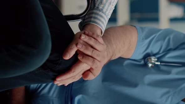 Vertical Video Close Up of Hands of Man Nurse Comforting Senior Patient alt