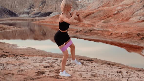 Woman working out on lifeless dried locality