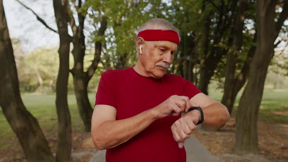 Senior Sport Runner Man Using Smart Watch Tapping Touchscreen, Tracking Result After Fitness Workout alt