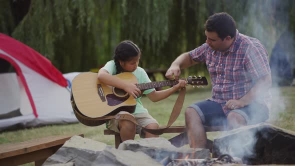 Kids at summer camp around campfire