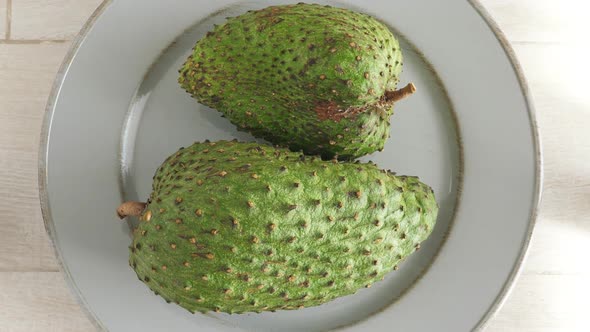 Closeup of Green Soursop Graviola, Exotic, Tropical Fruit Guanabana on Plate alt