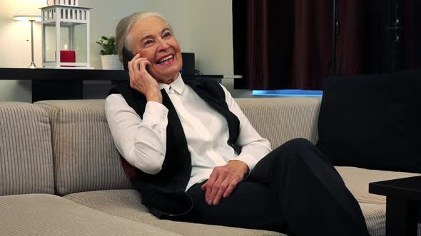 Old Happy Caucasian Woman Phone in Living Room and Smile alt
