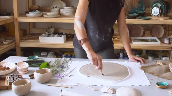 Woman Hands Using Rolling Pin, Ceramic Dish.