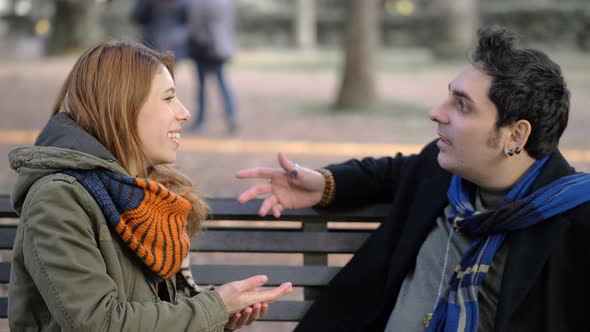 rejection, unrequited love.Young man refusing to kiss a woman in the park alt