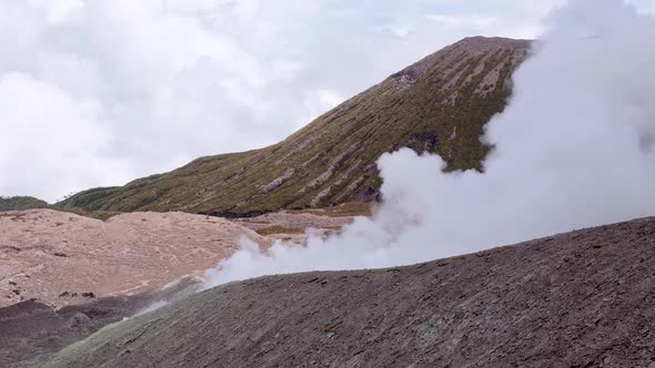 Billowing thick white smoke pouring from Mt Balbi volcano on tropical island of Bougainville, Papua alt