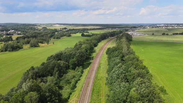 Railway Through green grassed countryside, Aerial alt