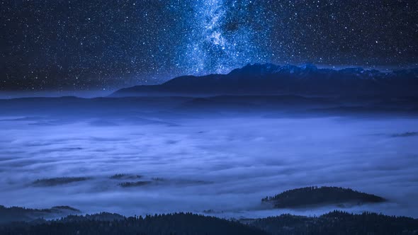 Milky way over flowing clouds in the Tatra Mountains at night, Poland, timelapse, 4K alt